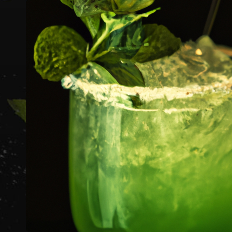 Close-up of a Mint Julep Margarita garnished with fresh mint and lime in a frosted glass